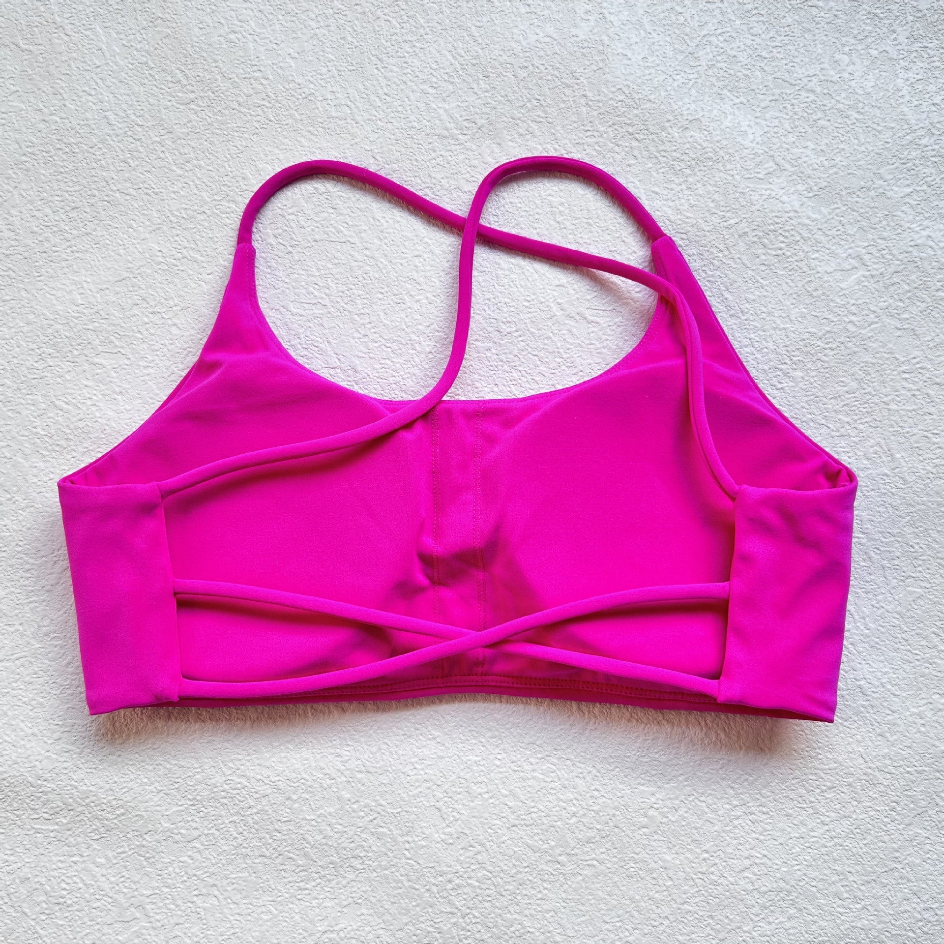 A nude fitness bra with thin straps and a cut-out back(Sports Bra)