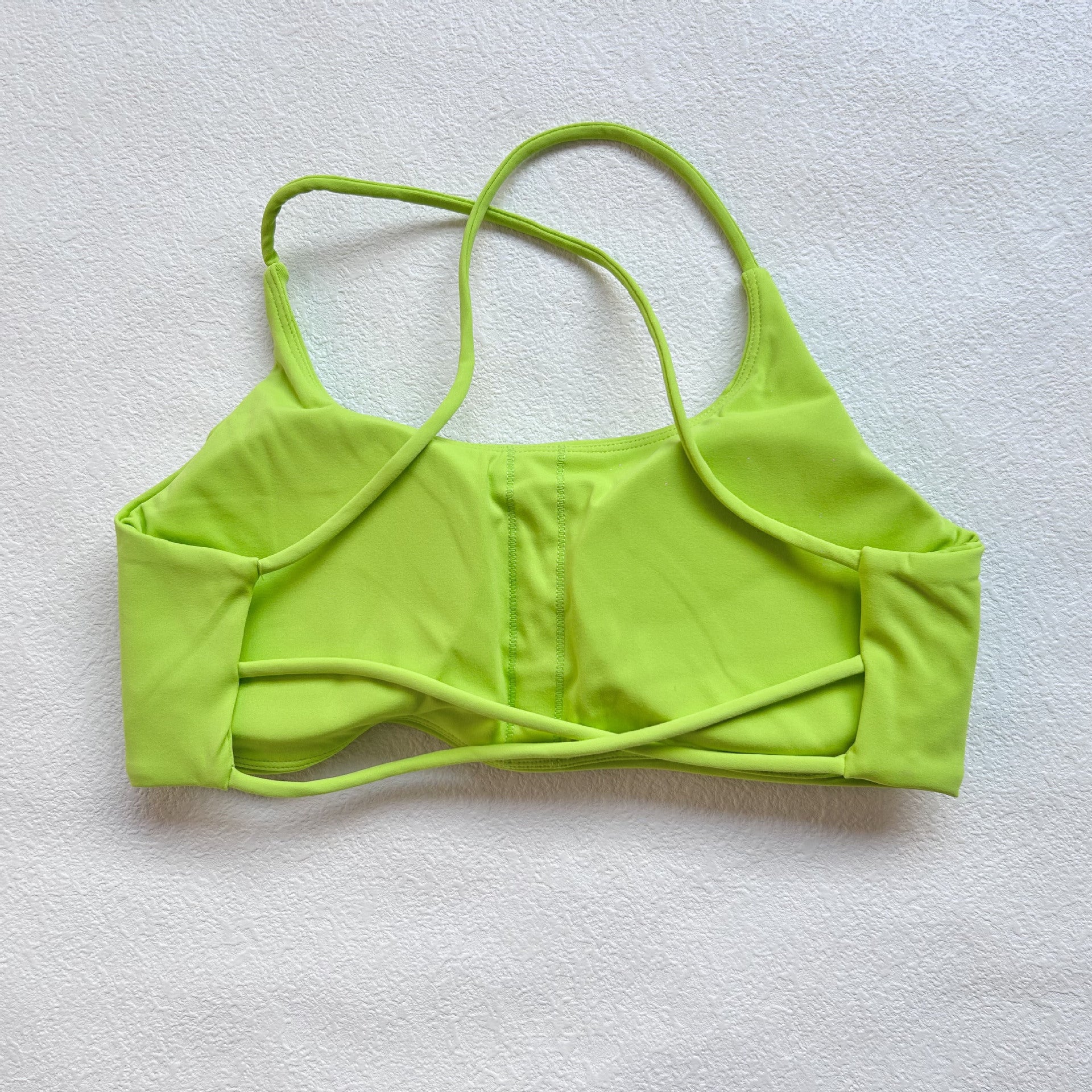 A nude fitness bra with thin straps and a cut-out back(Sports Bra)